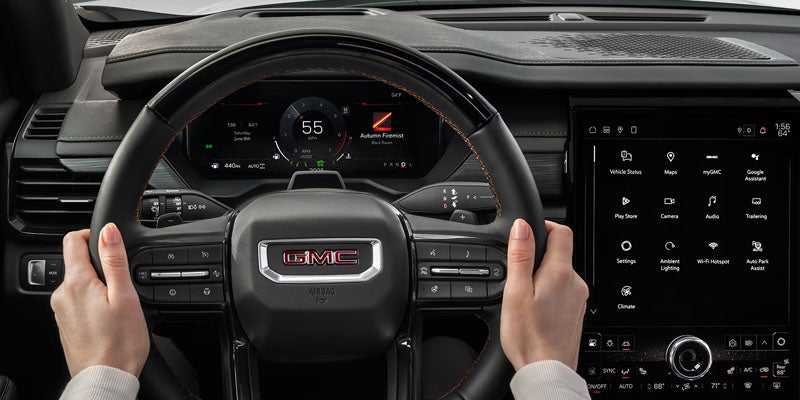 Hand holding Steering wheel of Acadia Denali Ultimate