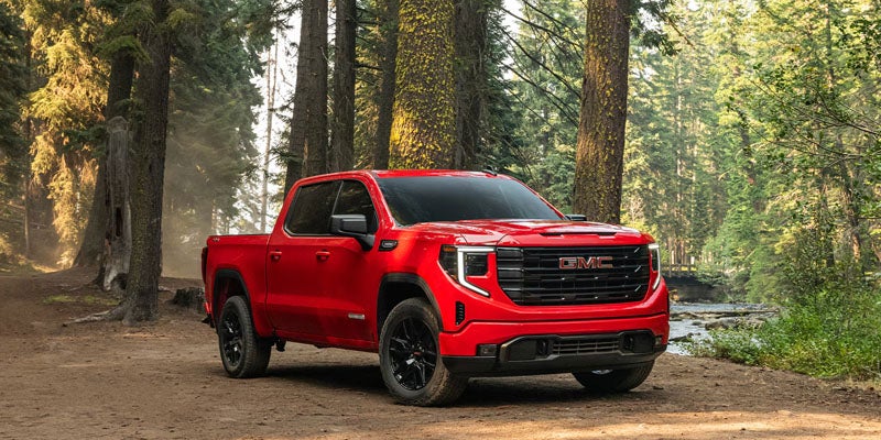 2026 GMC Sierra 1500 driving through a forest trail