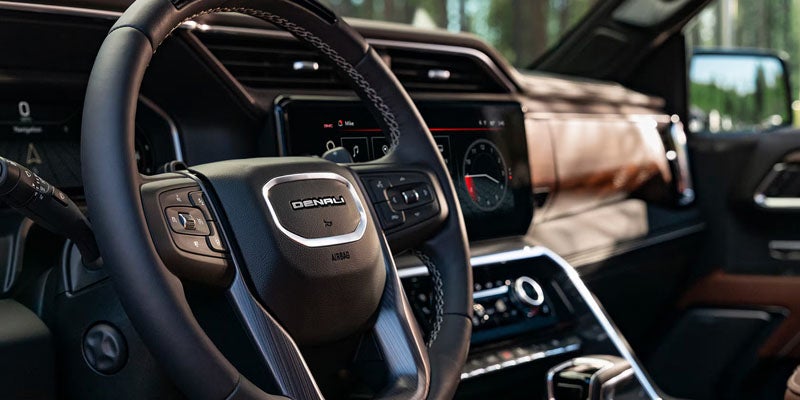 Sierra 1500 premium interior with leather steering wheel and dashboard