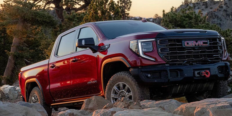 Sierra 1500 red pickup truck highlighting available trim levels and off-road capability