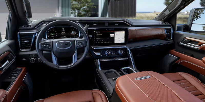 Driver-focused interior with steering wheel and digital display in the 2026 GMC Sierra 2500 HD Pro