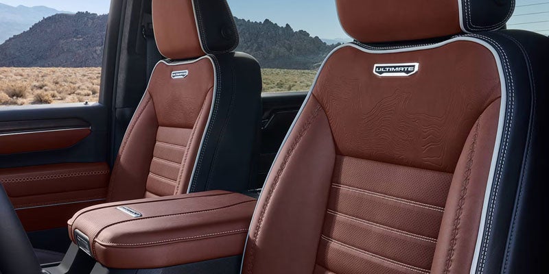 Front seats and center console inside the 2026 GMC Sierra 2500 HD Pro