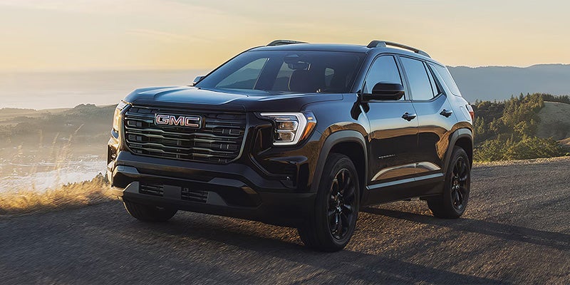 2026 GMC Terrain Denali front exterior on a scenic road